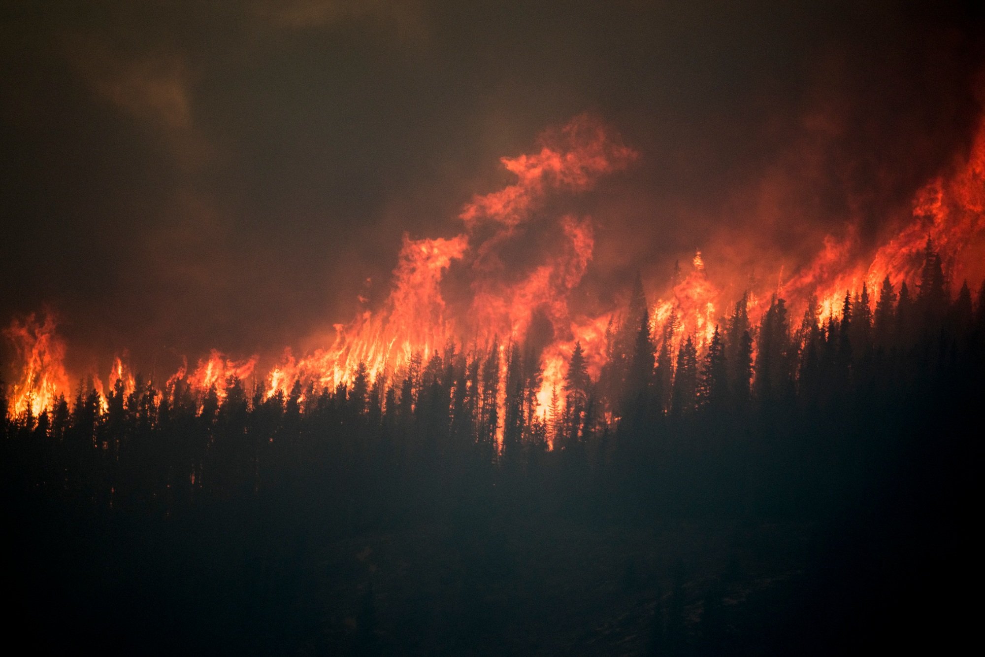 A wildfire engulfs the Chetamon region in the Canadian Rocky Mountains